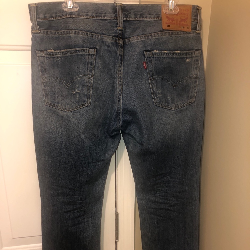 Ripped denim blue Levi Strauss 511 jeans